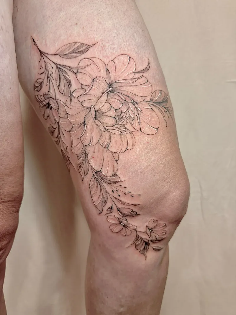Tatuaggio floreale fine line su coscia e ginocchio, copertura di cicatrici